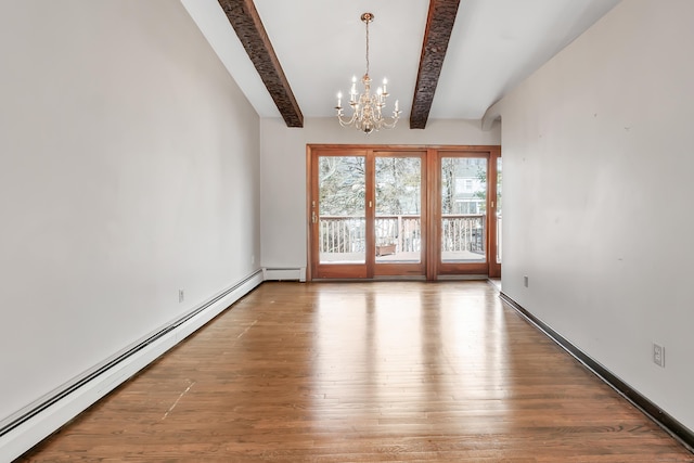 spare room featuring a baseboard heating unit, beamed ceiling, wood finished floors, and a notable chandelier