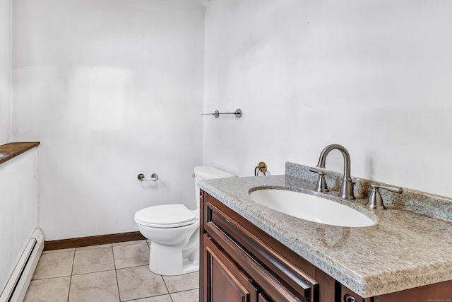 bathroom featuring toilet, a baseboard heating unit, vanity, baseboards, and tile patterned floors