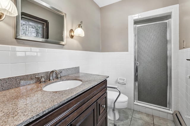 bathroom with toilet, a shower stall, baseboard heating, and tile walls