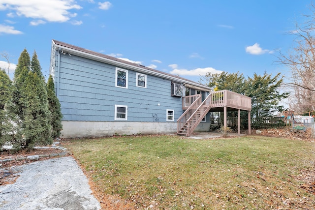 rear view of house with stairs, a lawn, and a wooden deck