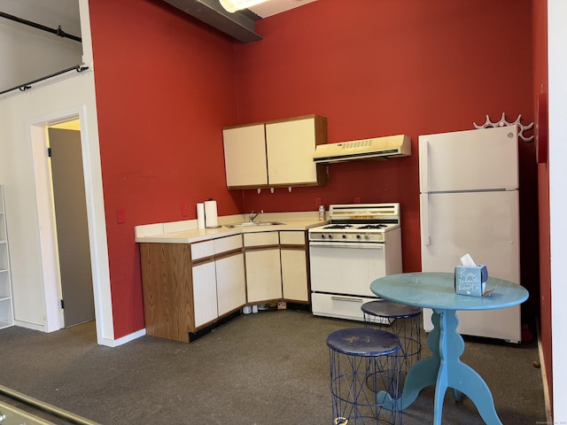 kitchen with white appliances, light countertops, a sink, and extractor fan