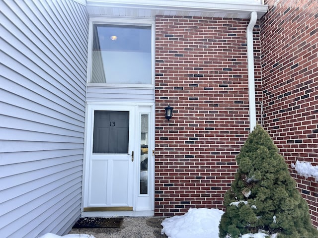 entrance to property with brick siding