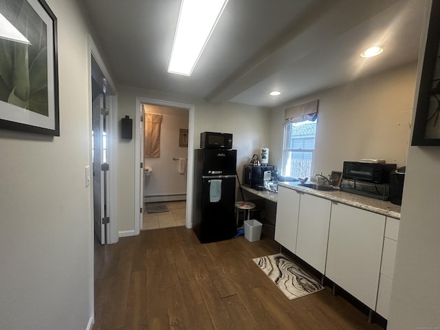17 Blair St, Milford, CT 06460 - kitchen featuring black microwave, a baseboard radiator, a sink, white cabinets, and dark wood-style floors