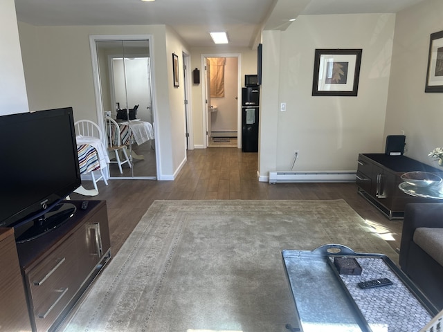 17 Blair St, Milford, CT 06460 - living area with a baseboard heating unit, a baseboard radiator, wood finished floors, and baseboards