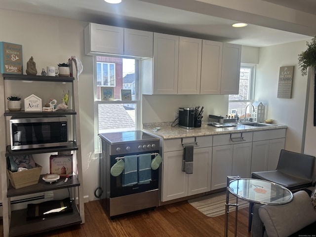 17 Blair St, Milford, CT 06460 - kitchen with stainless steel appliances, dark wood-type flooring, a sink, white cabinets, and light stone countertops