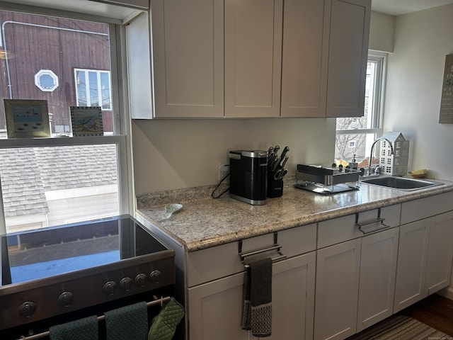 17 Blair St, Milford, CT 06460 - kitchen with stove, light stone counters, and a sink