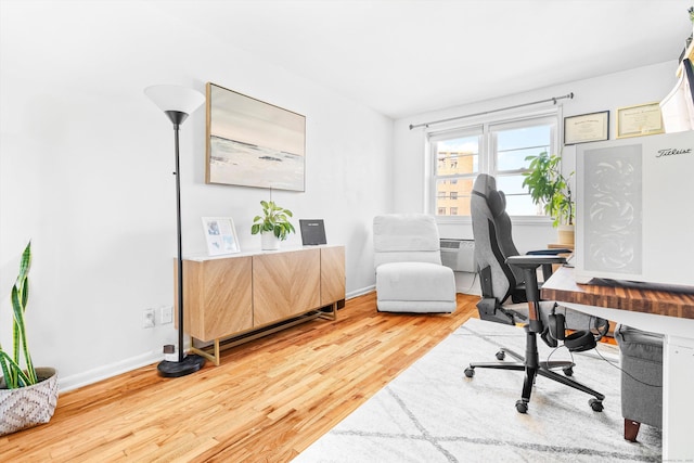 office space with wood finished floors and baseboards