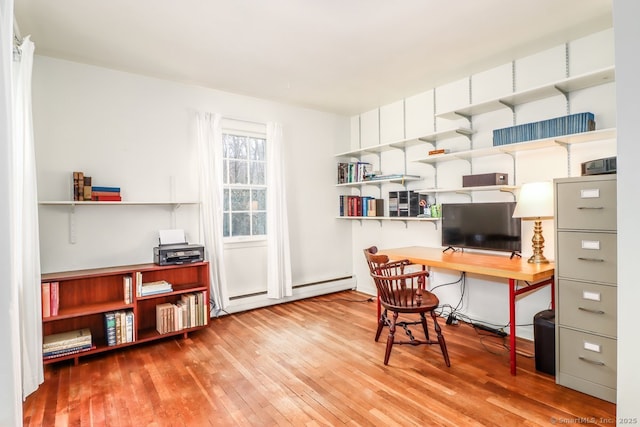 office with hardwood / wood-style flooring and baseboard heating