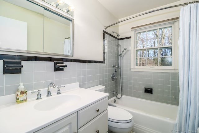 full bathroom with toilet, shower / bath combo, vanity, and tile walls