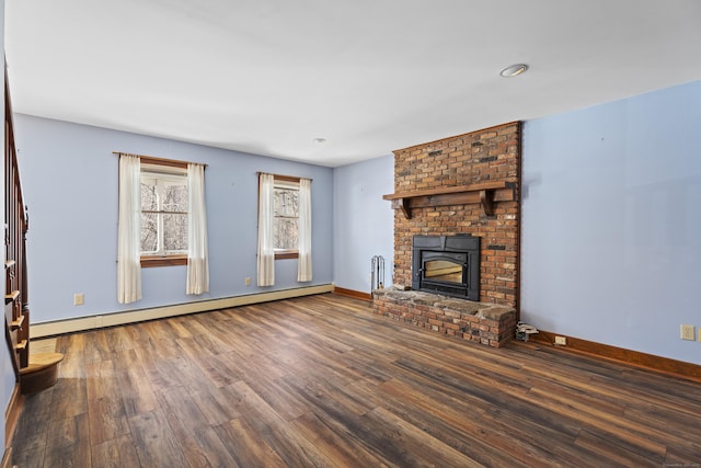 unfurnished living room featuring a brick fireplace, baseboards, baseboard heating, and wood finished floors