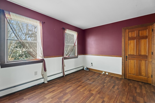 unfurnished room featuring a baseboard radiator and wood finished floors