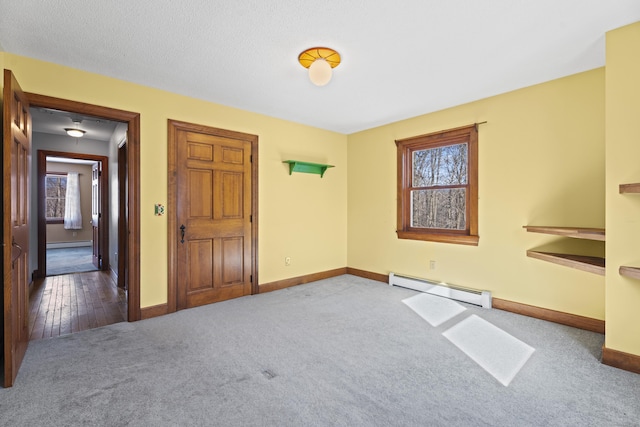 interior space featuring a baseboard radiator, baseboards, and carpet flooring