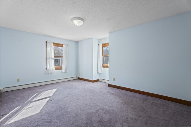 carpeted spare room with a textured ceiling, baseboard heating, and baseboards