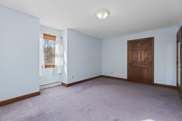 unfurnished bedroom with carpet floors, a baseboard radiator, and baseboards