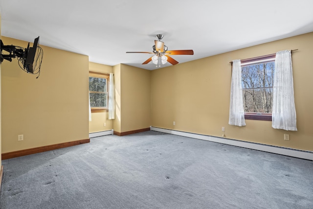 unfurnished room featuring carpet floors, baseboard heating, and a wealth of natural light