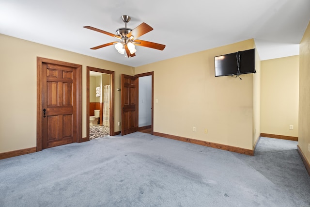 unfurnished bedroom with carpet flooring, connected bathroom, and baseboards