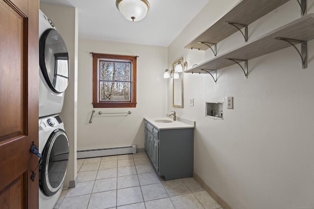 clothes washing area featuring a baseboard radiator, light tile patterned flooring, laundry area, stacked washer / dryer, and a sink