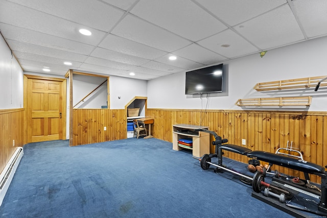 workout area with a wainscoted wall, recessed lighting, baseboard heating, carpet flooring, and wooden walls