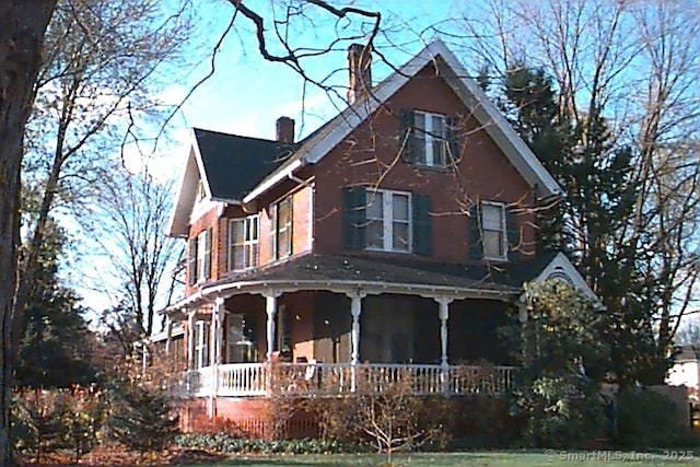 view of front of house with a porch and a chimney