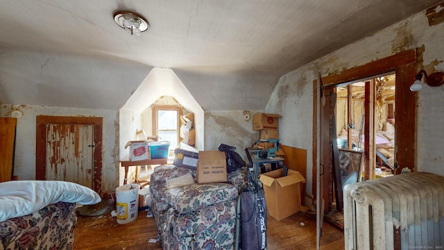 bonus room featuring radiator, vaulted ceiling, and hardwood / wood-style floors