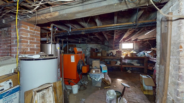 below grade area featuring water heater and brick floor