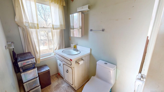 half bath featuring toilet and vanity