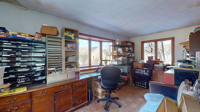 home office featuring a textured ceiling and plenty of natural light