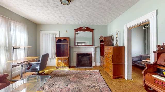 office space featuring a fireplace and a textured ceiling