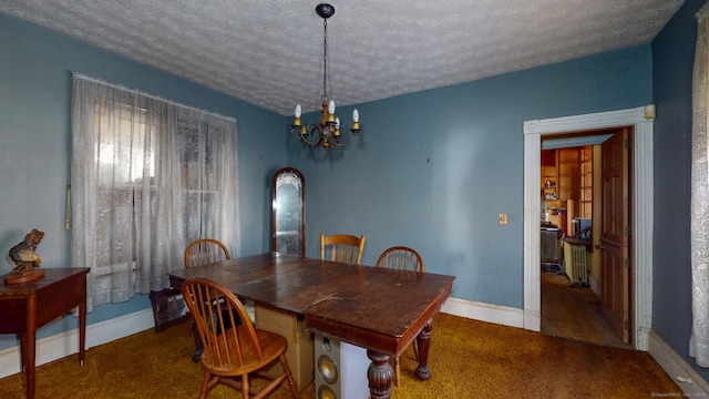 dining room featuring carpet, a textured ceiling, baseboards, and an inviting chandelier