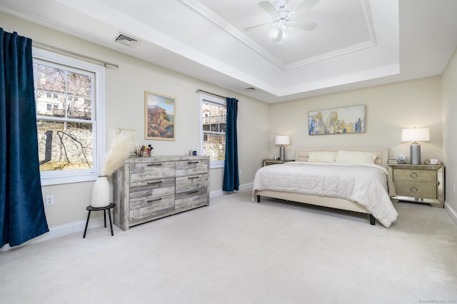 bedroom with carpet floors, a raised ceiling, crown molding, and baseboards