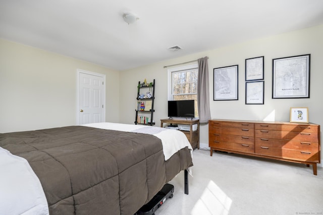 bedroom with visible vents and light colored carpet