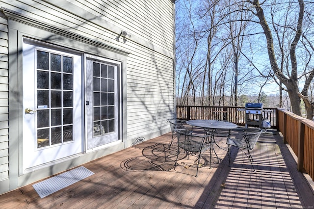 wooden terrace with outdoor dining space