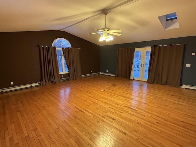 spare room with lofted ceiling with beams, a baseboard heating unit, a ceiling fan, french doors, and hardwood / wood-style floors