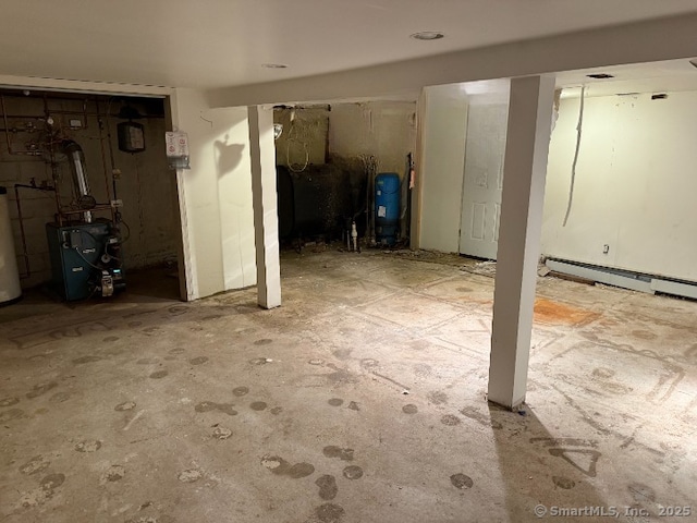 finished basement with water heater and a heating unit