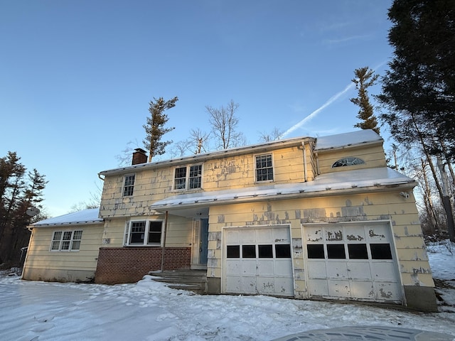 view of front facade featuring a garage, stone siding, and a chimney