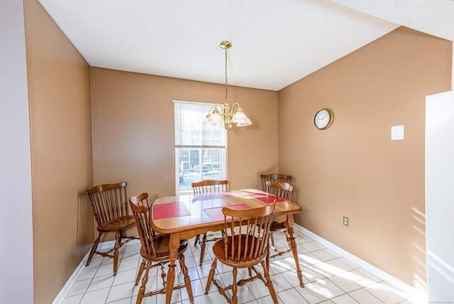 dining area featuring baseboards, light tile patterned floors, and a notable chandelier