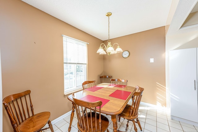 dining area featuring baseboards, light tile patterned flooring, and a notable chandelier