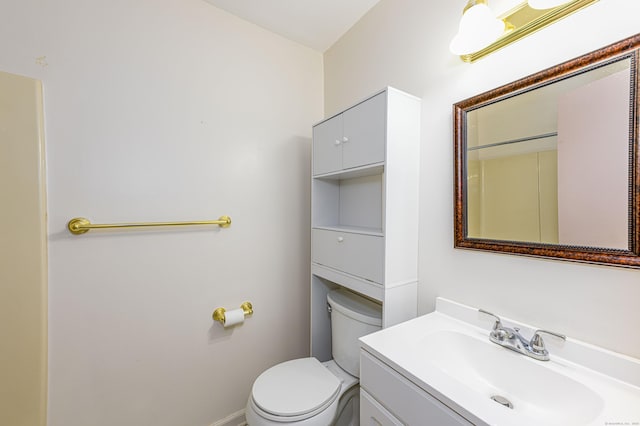 bathroom featuring toilet and vanity