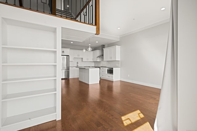 unfurnished living room with baseboards, dark wood finished floors, ornamental molding, a sink, and recessed lighting