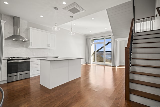 kitchen featuring tasteful backsplash, visible vents, wall chimney exhaust hood, dark wood-style flooring, and stainless steel electric range