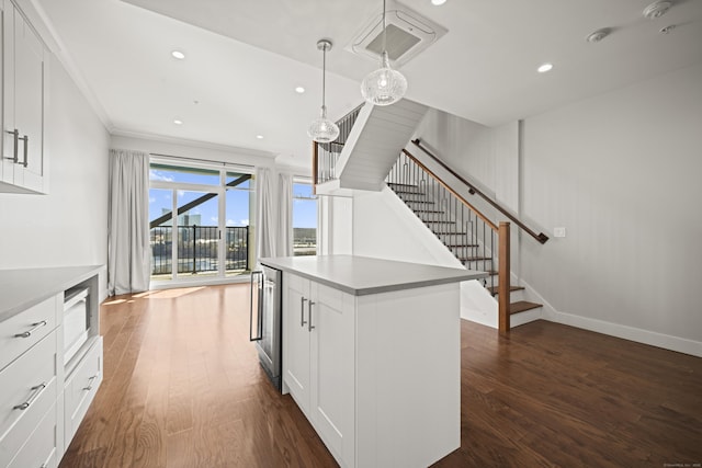 kitchen with wine cooler, white cabinetry, and dark wood-type flooring