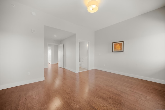 unfurnished room with baseboards and wood finished floors