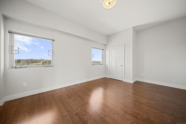 unfurnished bedroom with baseboards and wood finished floors