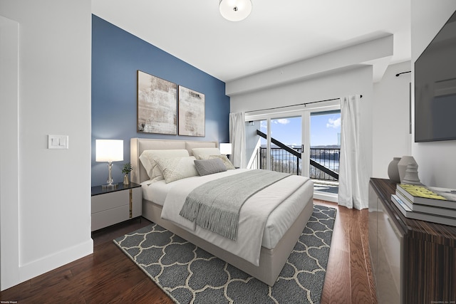 bedroom featuring access to outside, dark wood-style flooring, and baseboards