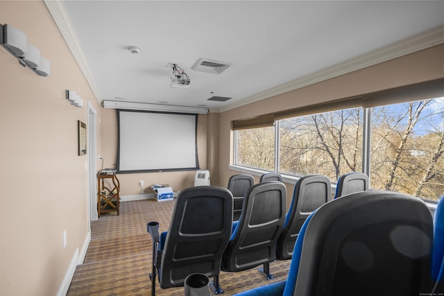 carpeted home theater featuring visible vents, ornamental molding, and baseboards