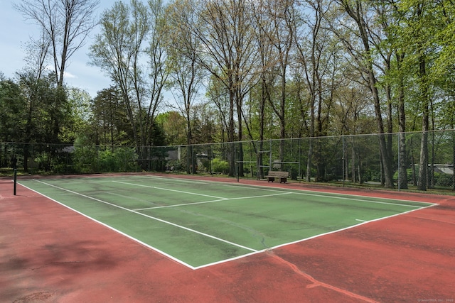 view of tennis court with fence