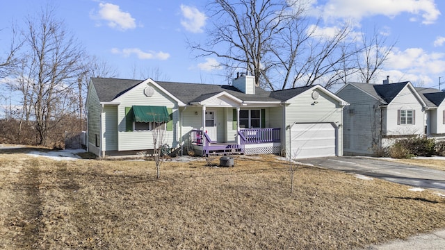 ranch-style home with driveway, covered porch, and a chimney