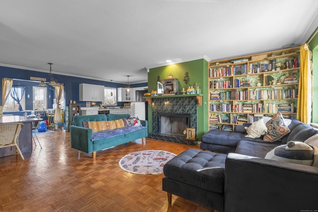 living room featuring a fireplace and crown molding