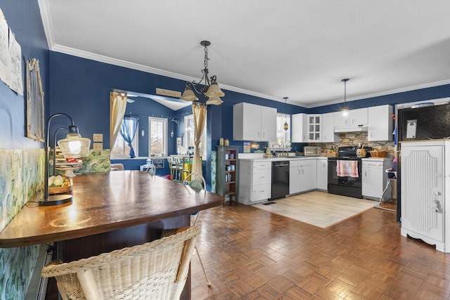 kitchen featuring decorative light fixtures, white cabinets, under cabinet range hood, and black appliances