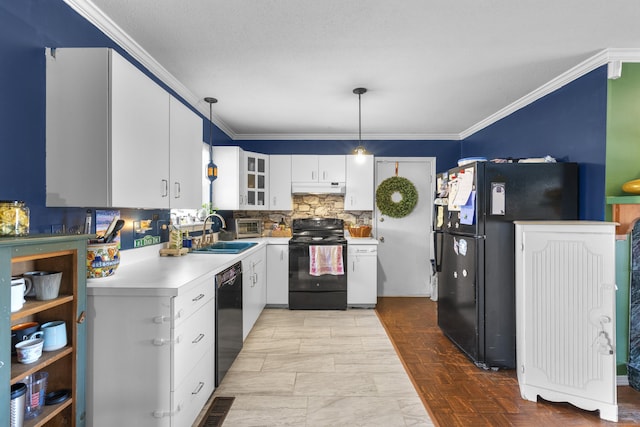 kitchen featuring light countertops, ornamental molding, a sink, under cabinet range hood, and black appliances